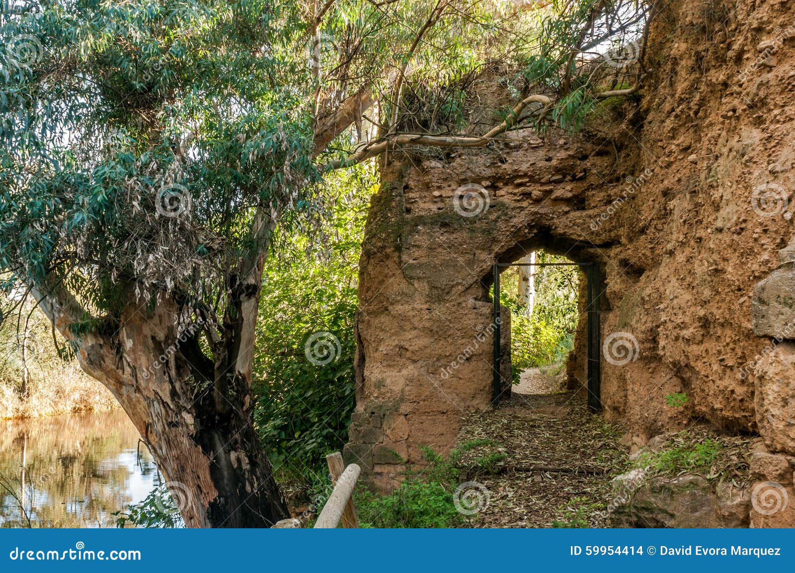 door inside the rampart of medieval stone that surrounds village of niebla, huelva, spain